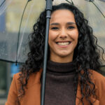 Woman smiling in the rain in Mill Creek and [test_shortcode]